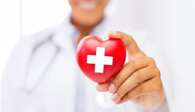 Doctor holding Red Cross heart